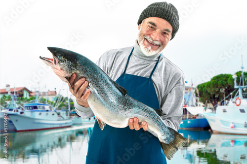 Photo: Fisherman holding a big atlantic salmon fish Fisherman holding a big atlantic salmon fish