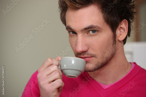 Photo: Young man drinking an expresso Young man drinking an expresso