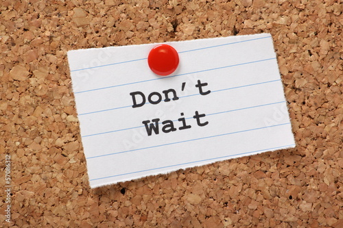 Photo: Don't Wait on a paper note pinned to a cork notice board Don't Wait on a paper note pinned to a cork notice board