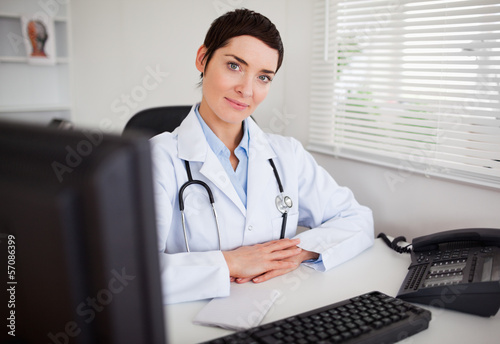 Photo: Serious female doctor looking at the camera Serious female doctor looking at the camera