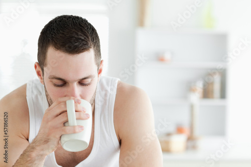 Photo: Close up of a man having coffee Close up of a man having coffee