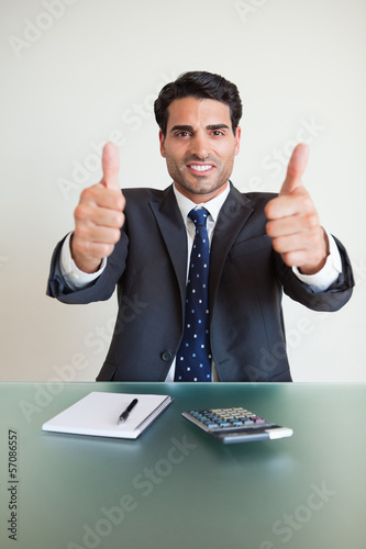 Photo: Portrait of an accountant with the thumbs up Portrait of an accountant with the thumbs up