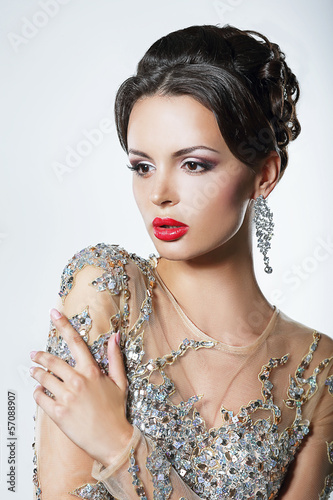 Photo: Elegance. Luxurious Woman in Dress with Sequins and Jewels Elegance. Luxurious Woman in Dress with Sequins and Jewels