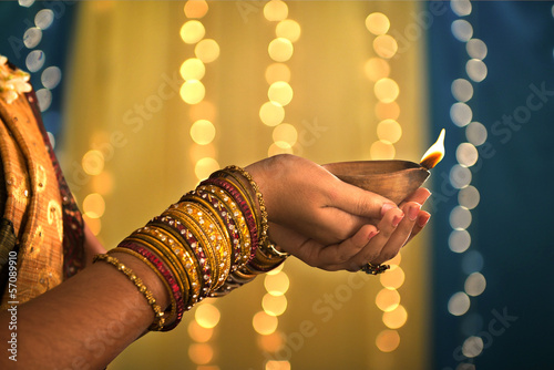 Photo: diwali festival of lights , hands holding indian oil lamp diwali festival of lights , hands holding indian oil lamp
