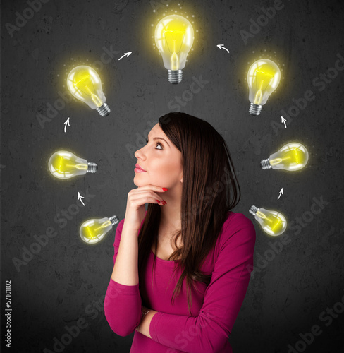 Photo: Young woman thinking with lightbulb circulation around her head Young woman thinking with lightbulb circulation around her head