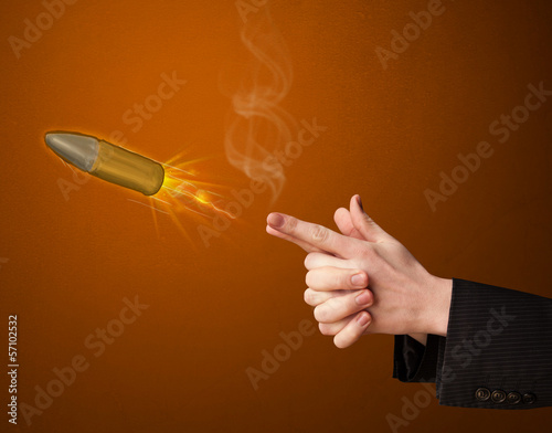 Photo: Gun shaped male hand with bullet Gun shaped male hand with bullet