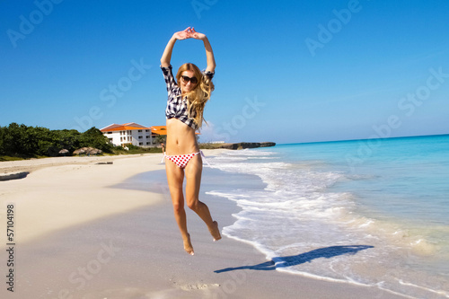 Photo: Pretty woman relaxing on the beach Pretty woman relaxing on the beach