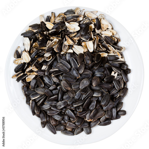 Photo: top view of sunflower seeds and husks on plate top view of sunflower seeds and husks on plate