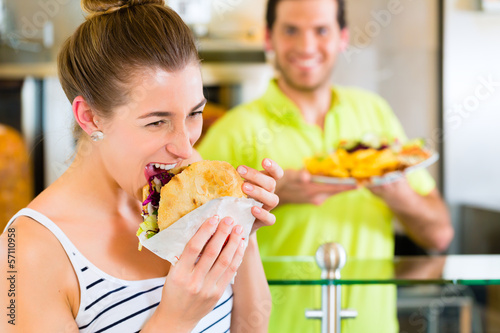 Photo: Kebab - customer and hot Doner with fresh ingredients Kebab - customer and hot Doner with fresh ingredients