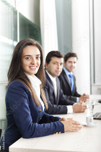 Photo: Business team smiling at the office, lined up Business team smiling at the office, lined up