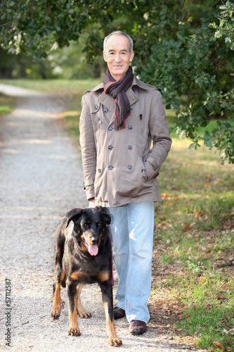 Photo: Man walking a dog Man walking a dog