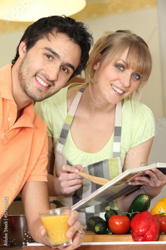 Photo: Couple following a recipe Couple following a recipe