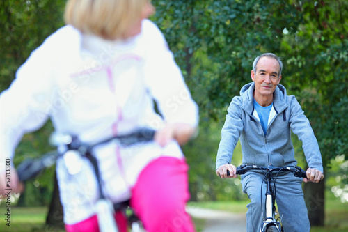 Photo: Middle-aged couple on a bike ride Middle-aged couple on a bike ride