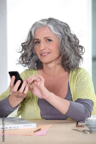 Photo: Woman sending text message Woman sending text message