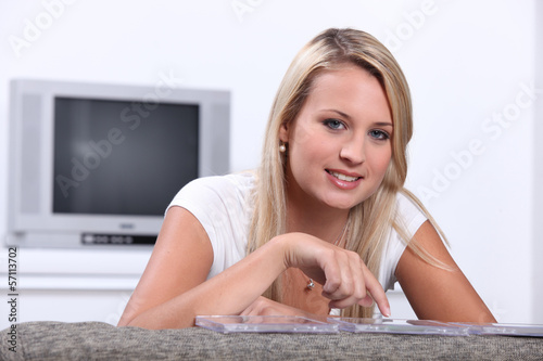 Photo: Teenage girl choosing CD Teenage girl choosing CD