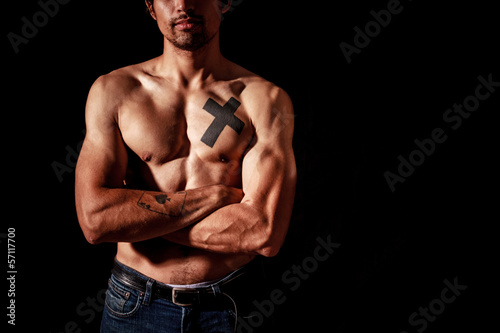 Photo: Young muscular man with tattoos Young muscular man with tattoos