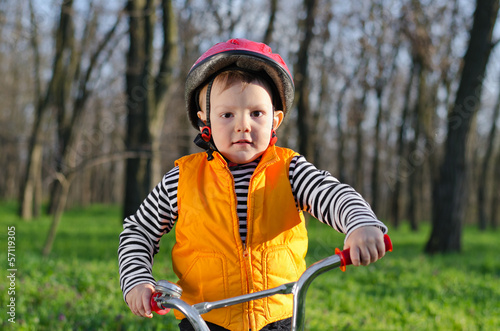 Photo: Little boy playing with his bicycle Little boy playing with his bicycle