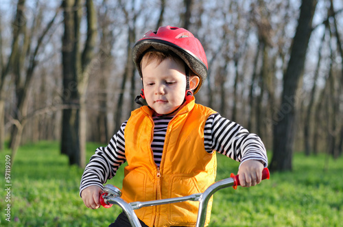 Photo: Little boy playing with his bicycle Little boy playing with his bicycle