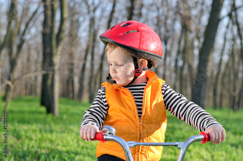 Photo: Little boy playing with his bicycle Little boy playing with his bicycle