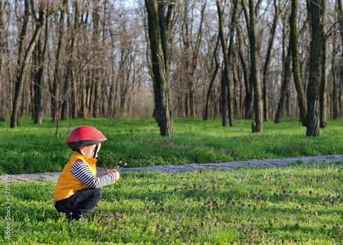Photo: Little boy playing outdoors in woodland Little boy playing outdoors in woodland