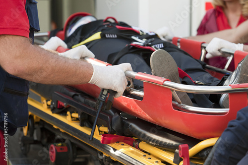 Photo: paramedics rushing patient into an ambulance paramedics rushing patient into an ambulance