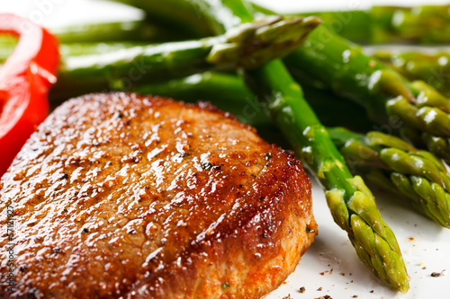 Photo: Grilled steaks and asparagus Grilled steaks and asparagus