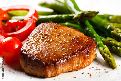 Photo: Grilled steaks and asparagus Grilled steaks and asparagus
