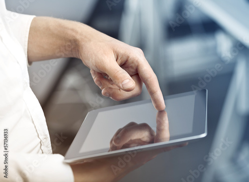Photo: hand holding tablet hand holding tablet