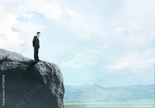 Photo: man standing on rock man standing on rock