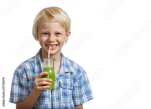 Photo: Cute young boy drinking green smoothie Cute young boy drinking green smoothie