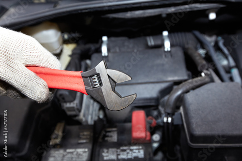 Photo: Hands of auto mechanic with wrench. Hands of auto mechanic with wrench.