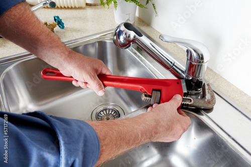 Photo: Plumber with a wrench. Plumber with a wrench.