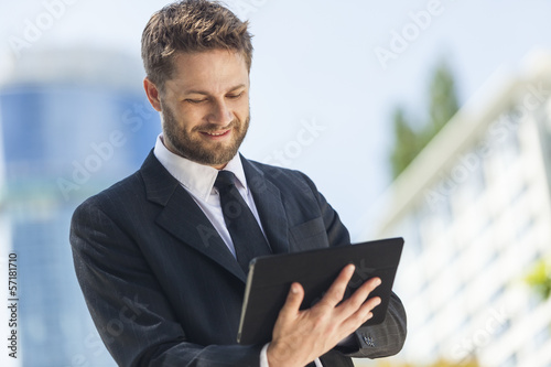 Photo: Businessman Using Tablet Computer Businessman Using Tablet Computer