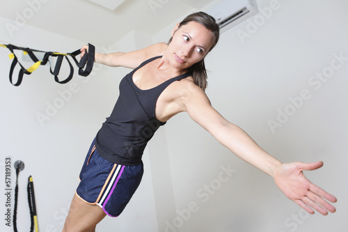 Photo: Woman doing trx suspension training Woman doing trx suspension training