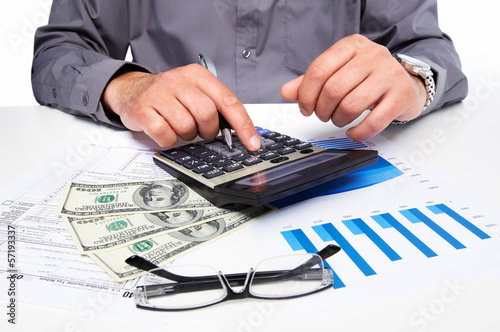 Photo: Hands of businessman with calculator. Hands of businessman with calculator.