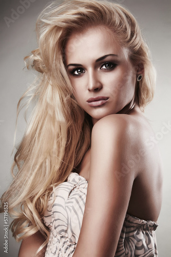 Photo: Beautiful blond woman in dress.passion.gray background Beautiful blond woman in dress.passion.gray background