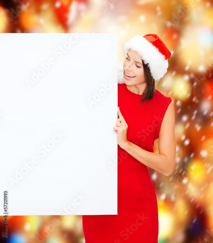 Photo: woman in santa helper hat with blank white board woman in santa helper hat with blank white board