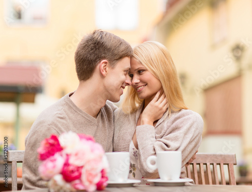 Photo: romantic happy couple kissing in the cafe romantic happy couple kissing in the cafe