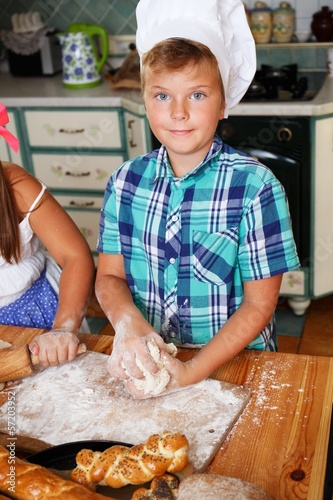 Photo: Young cook boy making homemade pastry Young cook boy making homemade pastry