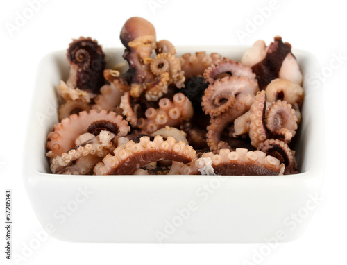 Photo: Tentacles of octopus in bowl isolated on white Tentacles of octopus in bowl isolated on white