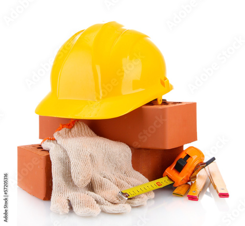 Photo: helmet, roulette, bricks and gloves isolated on white helmet, roulette, bricks and gloves isolated on white