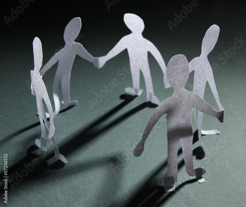 Photo: Paper people in social network concept on dark background Paper people in social network concept on dark background