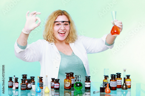 Photo: chemist woman with glassware ok sign up gesture isolated chemist woman with glassware ok sign up gesture isolated