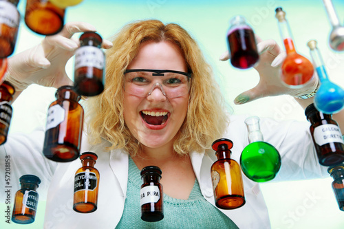 Photo: Crazy chemist woman with chemical glassware flask Crazy chemist woman with chemical glassware flask