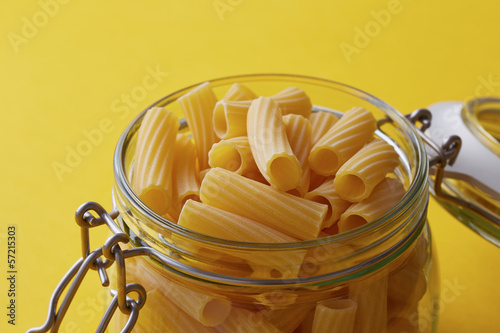 Photo: Raw rigatoni pasta on a glass jar Raw rigatoni pasta on a glass jar