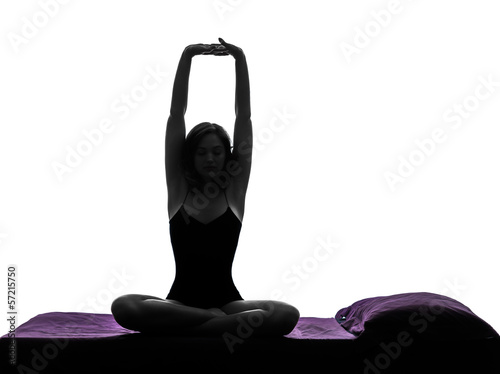 Photo: woman in bed waking up stretching arms silhouette woman in bed waking up stretching arms silhouette