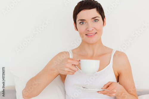 Photo: Young woman drinking coffee Young woman drinking coffee