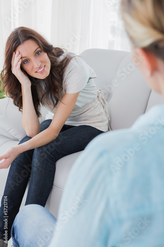 Photo: Happy woman sitting and looking at camera during therapy Happy woman sitting and looking at camera during therapy