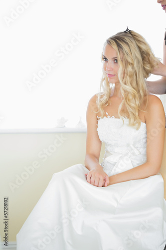 Photo: Beautiful blonde bride being prepared for the wedding Beautiful blonde bride being prepared for the wedding