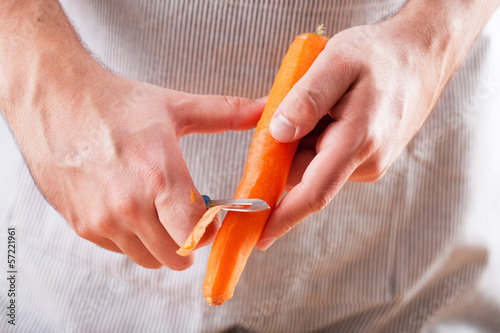 Photo: man hands peeling carrot man hands peeling carrot